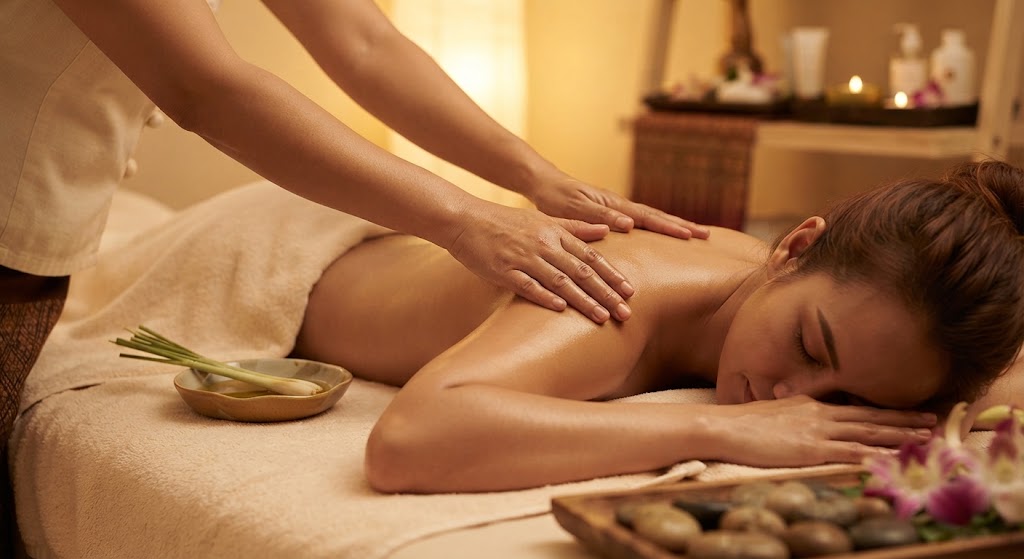 Professional therapist performing a relaxing Thai oil massage on a client's back in a serene spa setting.